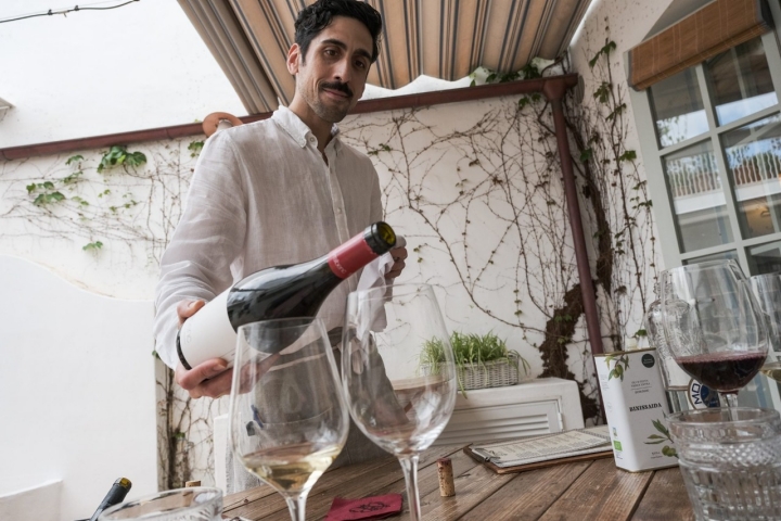 Esteban Muñoz, jefe de sala, sirviendo un tinto menorquín
