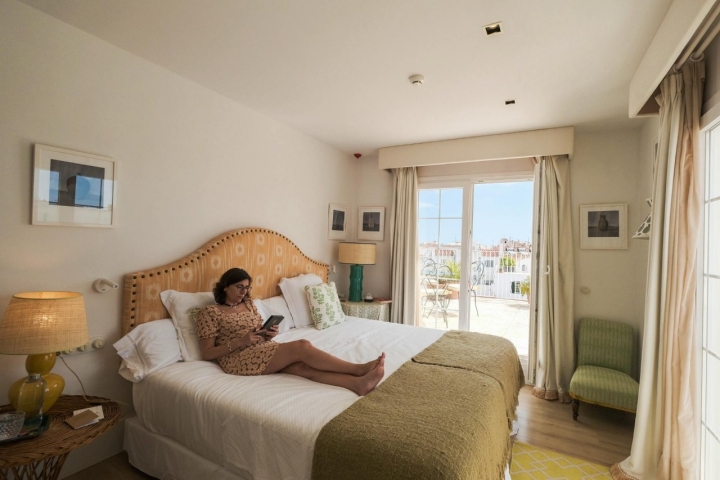 Una mujer lee sobre la cama de una de las habitaciones del 'Cristine Bedfor'.